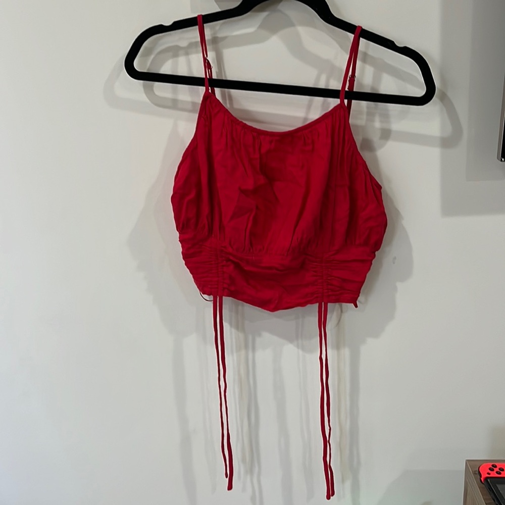 Cute red tank! Flows in the chest and tighter on the stomach.